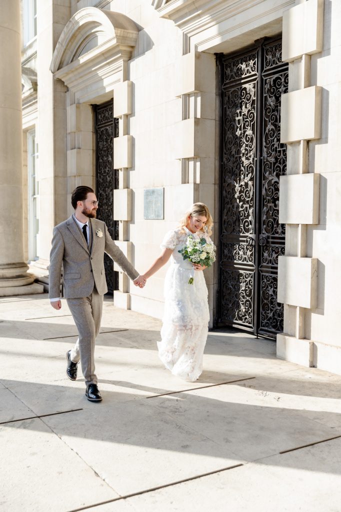 Bride and Groom walking naturally during portrait session after marriage at Leeds Civic Hall Wedding. For more information on how to feel comfortable infront of the camera at your wedding check out articles on the Christa Chadwick Photography Blog