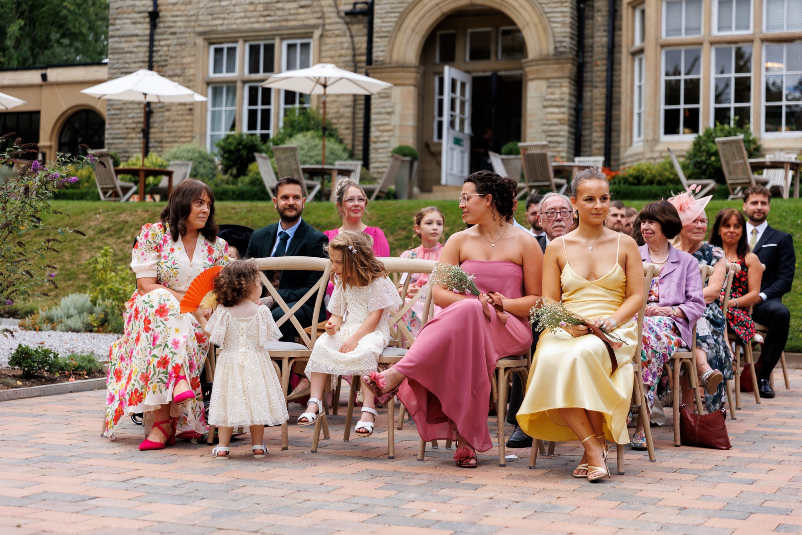 children and guests sit during outdoor wedding ceremony at woodlands hotel leeds